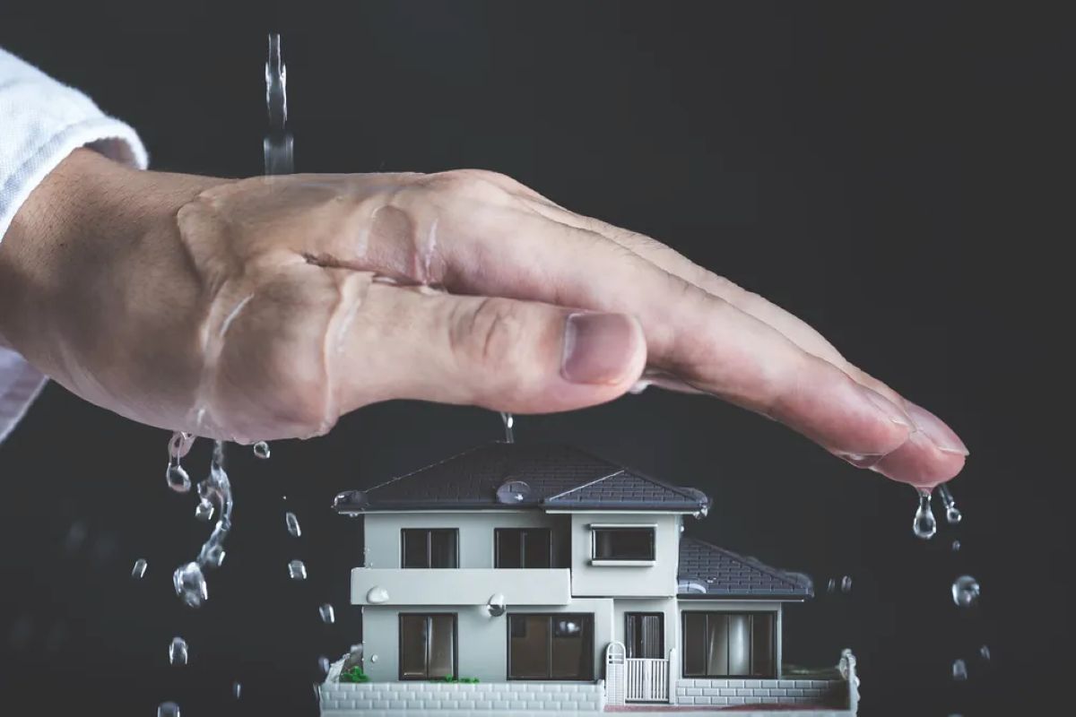 Hand protecting house from water